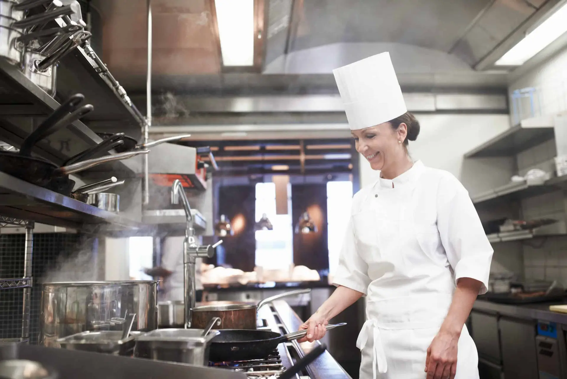 Commercial kitchen chef cooking with fire - kitchen hood suppression system protects restaurants in Northern Virginia
